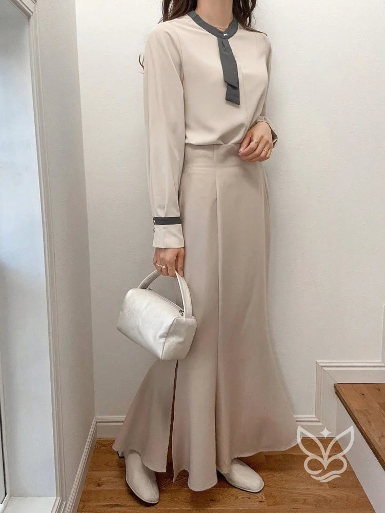Blusa Manga Longa Com Laço Na Gola E Detalhes Contrastantes Blusa Manga Longa Com Laço Na Gola E Detalhes Contrastantes